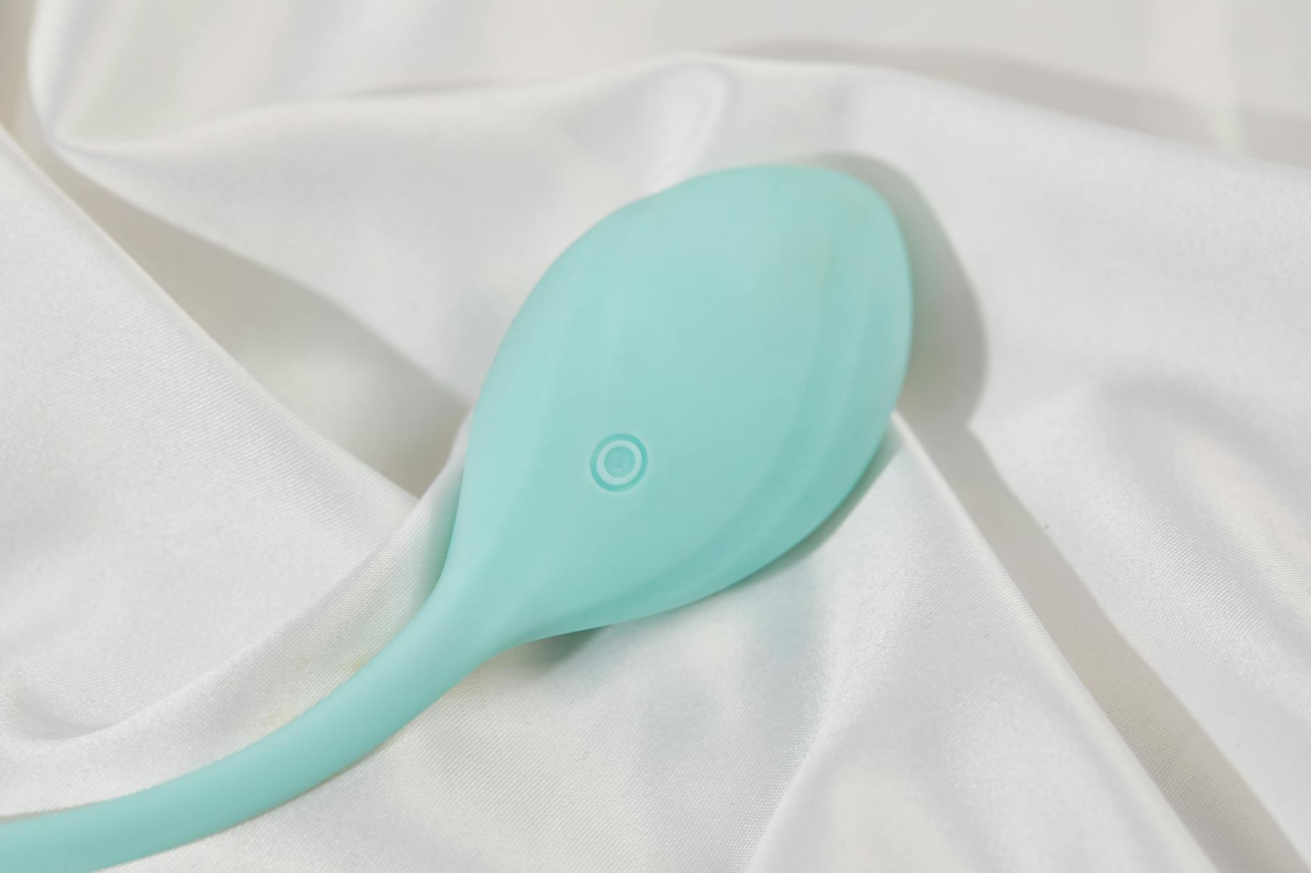 Stylish lemon vibrator on soft white silk, representing modern intimacy tools for couples